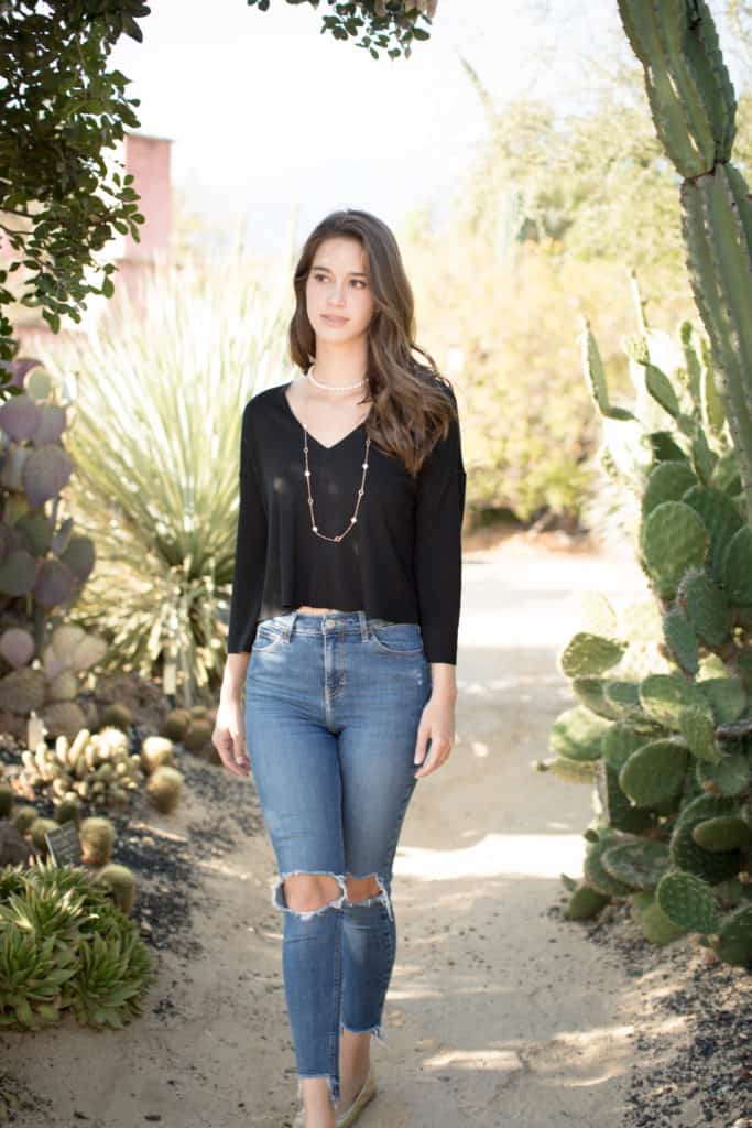 Torn jeans, simple black long-sleeved shirt and a strand of pearls. Image by Mika Larson Photography