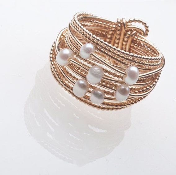 Layered pearl and metal rings.