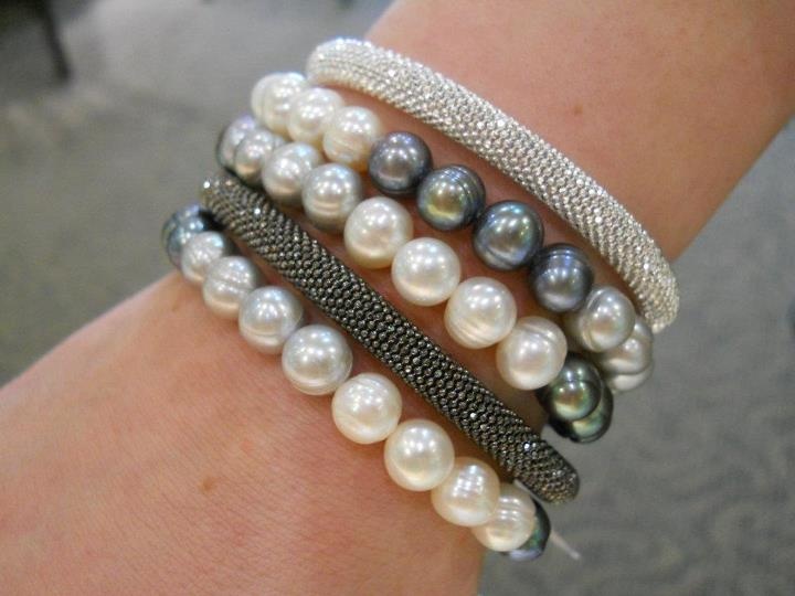 Pearl and metal bracelets layered.