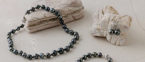 Tahitian pearl necklace and earrings in gray, green, and black tones
