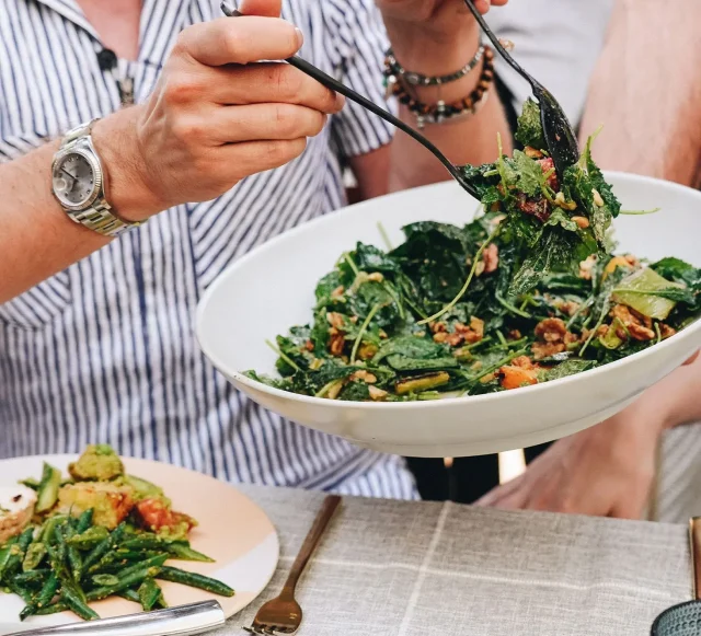 Serving a plate of delicious salad, cooked by a private chef.