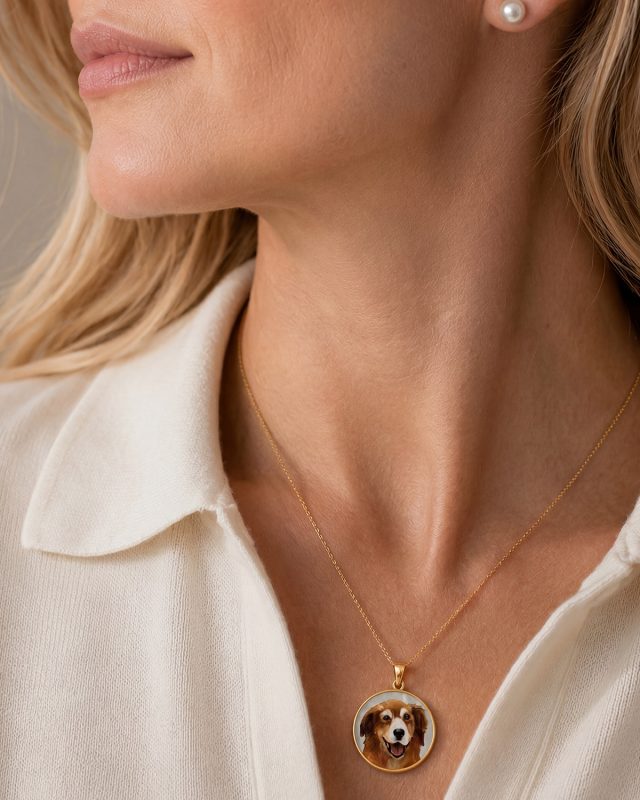 A woman wearing a custom pet portrait from The Pearl Source.